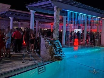 The pergola and pool crowd at a TampArotic Tampa Bay hotel takeover, seen from across the deck.