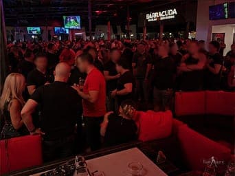 A dense club-takeover crowd mid-party at a TampArotic Tampa Bay night — faces blurred for privacy.